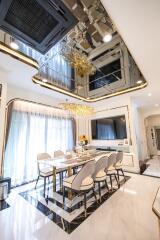 Elegant dining room with modern chandelier and reflective ceiling