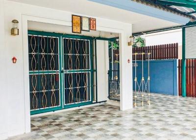 Front entrance of a residential building with tiled flooring and security grille doors