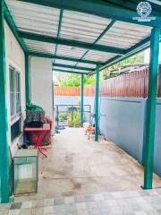 Covered patio area with metal roofing adjacent to a building