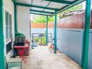 Covered patio area with metal roofing adjacent to a building