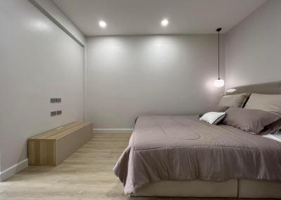 Modern bedroom with neutral tones and ambient lighting