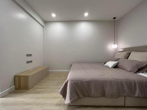 Modern bedroom with neutral tones and ambient lighting