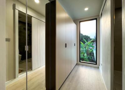 Modern hallway with built-in wardrobes and floor-to-ceiling window