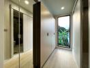 Modern hallway with built-in wardrobes and floor-to-ceiling window