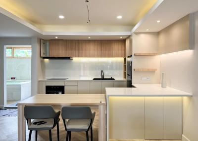 Modern kitchen with wooden cabinets and bright lighting