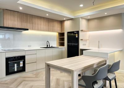 Modern kitchen with wooden accents and integrated appliances