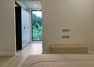 Modern bedroom with nature view and minimalistic design