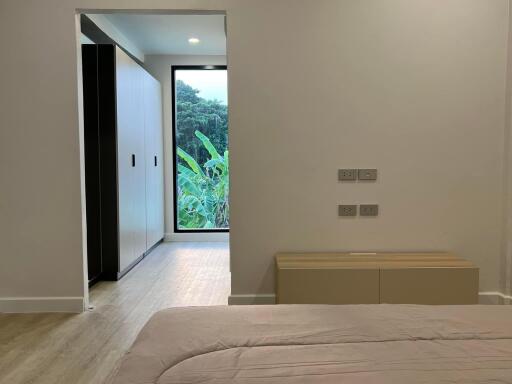 Modern bedroom with nature view and minimalistic design