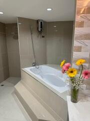 Modern bathroom with bathtub and elegant tiling