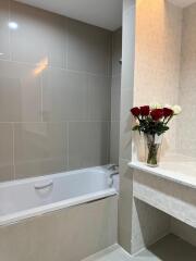 Modern bathroom with bathtub and flower decor