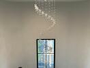 Elegant chandelier above a staircase with a view through a large window