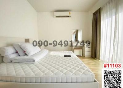 Spacious and bright bedroom with a king-sized bed and air conditioning