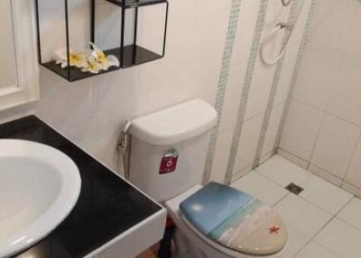 Compact bathroom with white sink and toilet