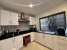 Modern kitchen with stainless steel appliances and mosaic backsplash