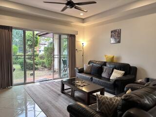 Cozy living room with large windows and garden view