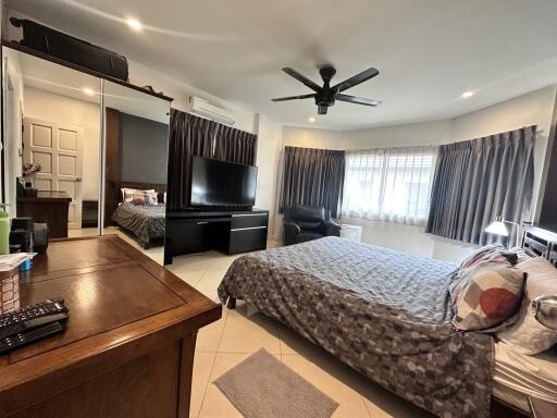 Spacious bedroom with modern furnishings and ample natural light