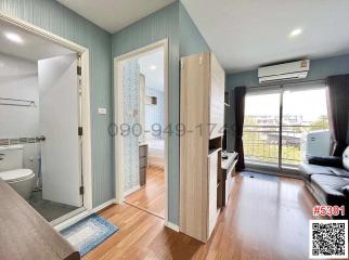 Cozy bedroom with ensuite bathroom, wooden flooring, wardrobe, and air conditioning