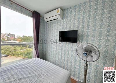 Cozy bedroom with air conditioning and flat-screen TV