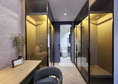 Modern hallway with glass doors, wood accents, and elegant lighting