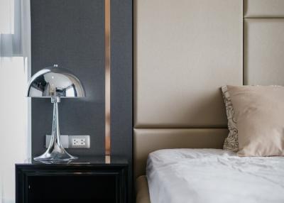 Modern bedroom with elegant bedside table and stylish lamp