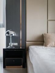 Modern bedroom with elegant bedside table and stylish lamp