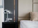 Modern bedroom with elegant bedside table and stylish lamp