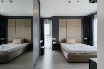 Modern bedroom with two beds and elegant interior design