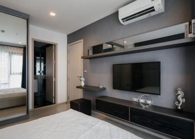 Modern bedroom interior with mounted television and air conditioning unit