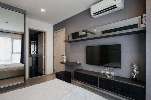 Modern bedroom interior with mounted television and air conditioning unit