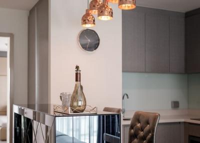 Modern kitchen with bar stools and stylish pendant lights
