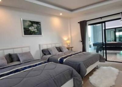 Spacious and well-lit bedroom with modern decor and en-suite access