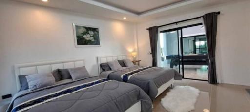 Spacious and well-lit bedroom with modern decor and en-suite access