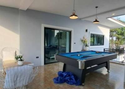 Spacious living room with pool table and modern decor