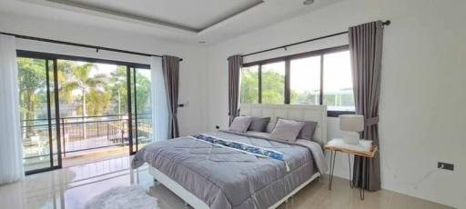 Spacious bedroom with balcony access and natural light