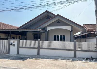 Modern single-story house with white fencing