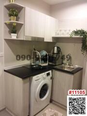 Compact modern kitchen with integrated appliances and washing machine