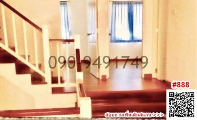 Interior view of a building with staircase and hardwood flooring