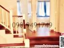 Interior view of a building with staircase and hardwood flooring