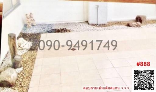 Spacious entrance area with tiled flooring and decorative pebbles