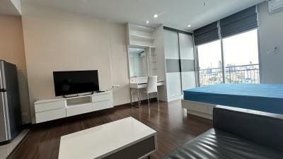 Studio apartment interior with combined living, sleeping, and dining areas