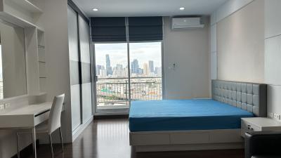 Modern bedroom with large windows and city view