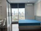 Modern bedroom with large windows and city view