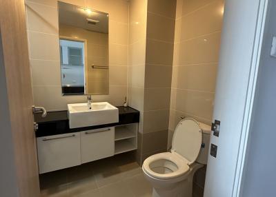 Modern bathroom interior with wall-mounted sink and toilet