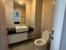 Modern bathroom interior with wall-mounted sink and toilet