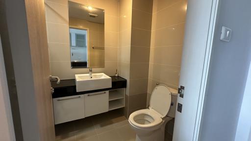 Modern bathroom interior with wall-mounted sink and toilet