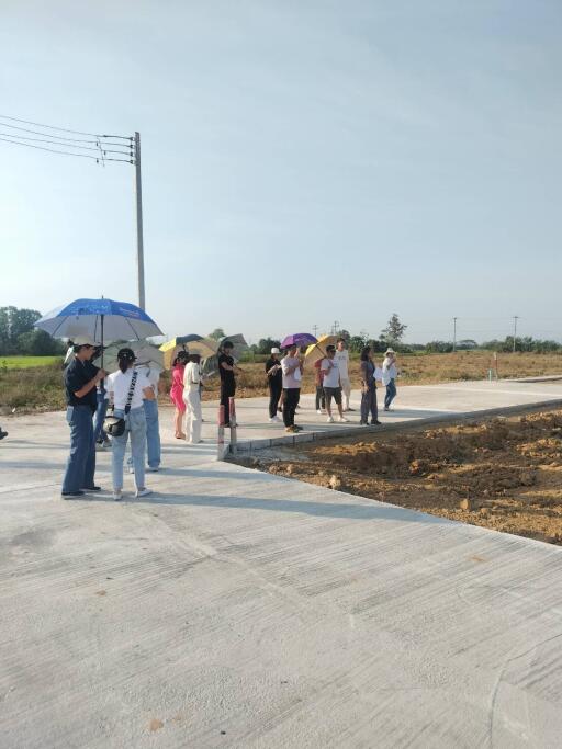 Group of people standing on a newly constructed road