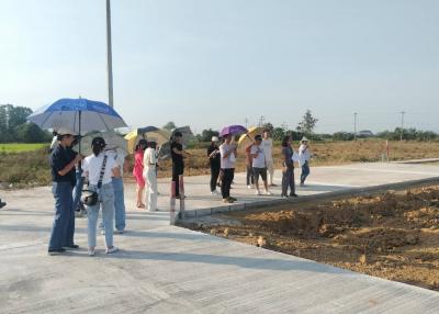 Group of people standing on a newly constructed road