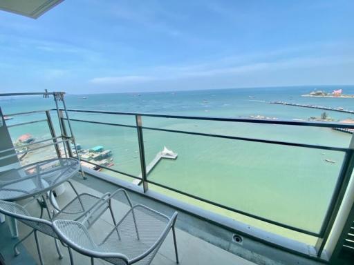 Ocean view from a high-rise balcony with seating