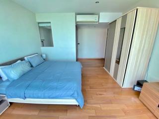 Spacious bedroom with hardwood flooring and built-in wardrobe