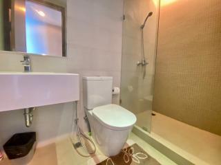 Modern bathroom interior with wall-mounted sink, toilet, and shower